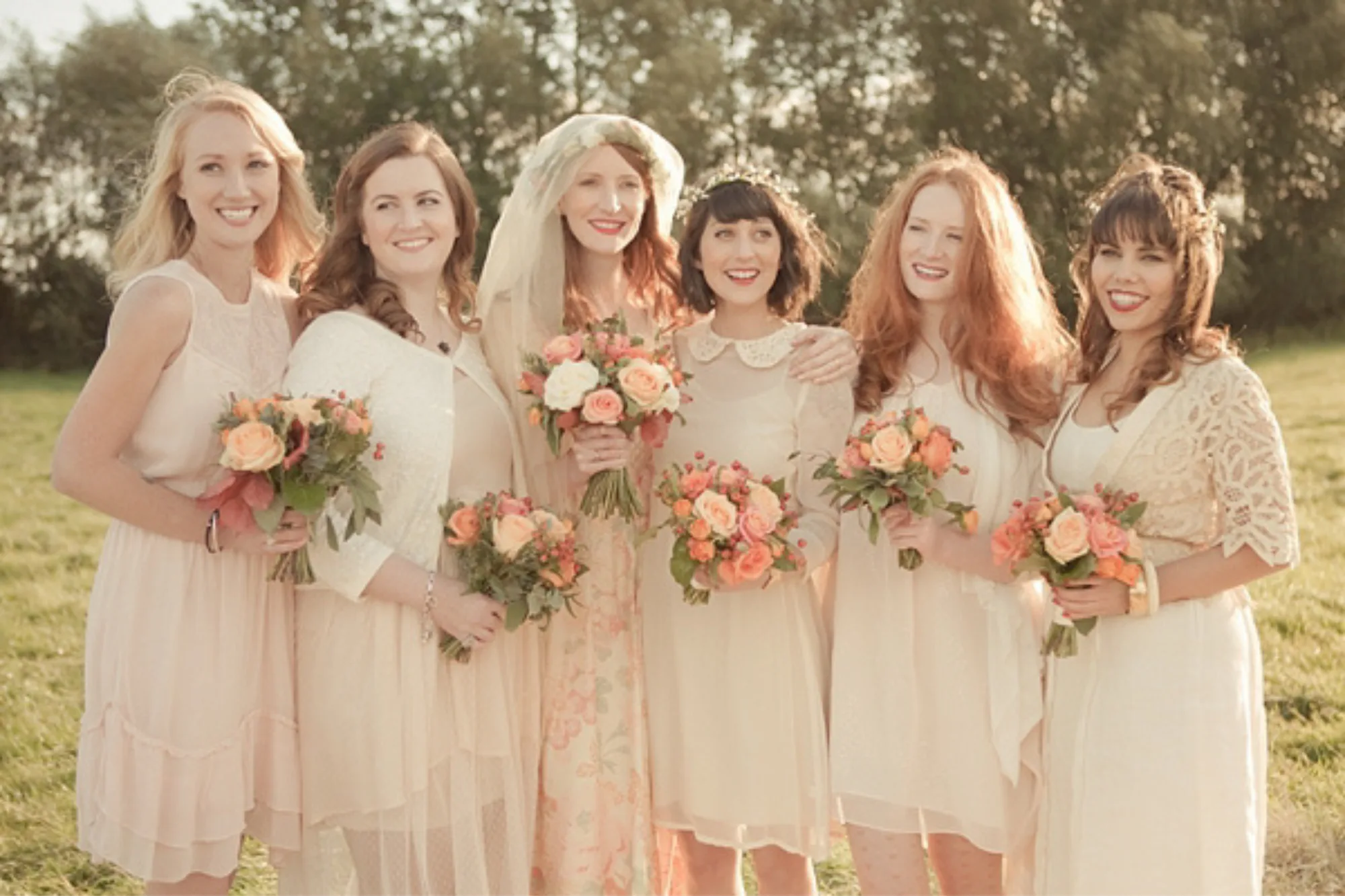 1970s inspired bride in peachy one wedding dress