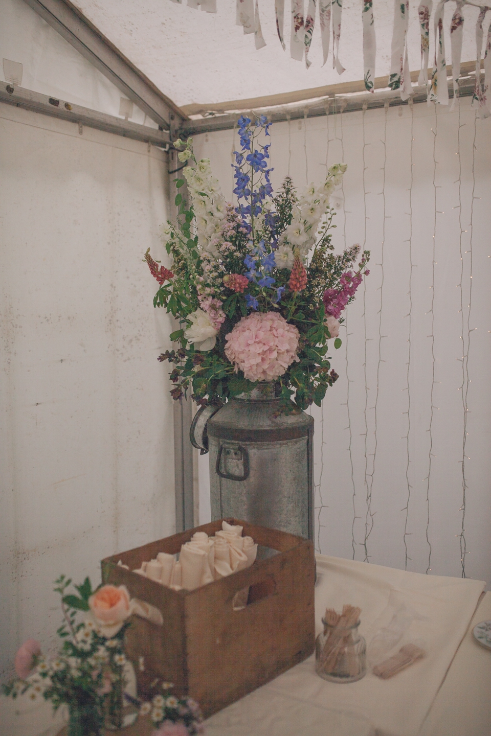 old milk churn and flowers