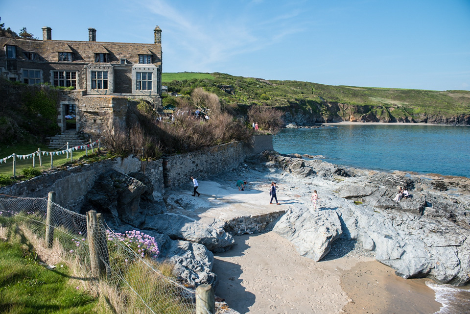 A bride wearing an elegant, backless lace wedding dress by Wilden Bride for her Cornish seaside and surf wedding. Photography by Marc Le Galle. cornwall wedding, cornish wedding, surfers wedding, marc le galle, wilden bride, backless wedding dress