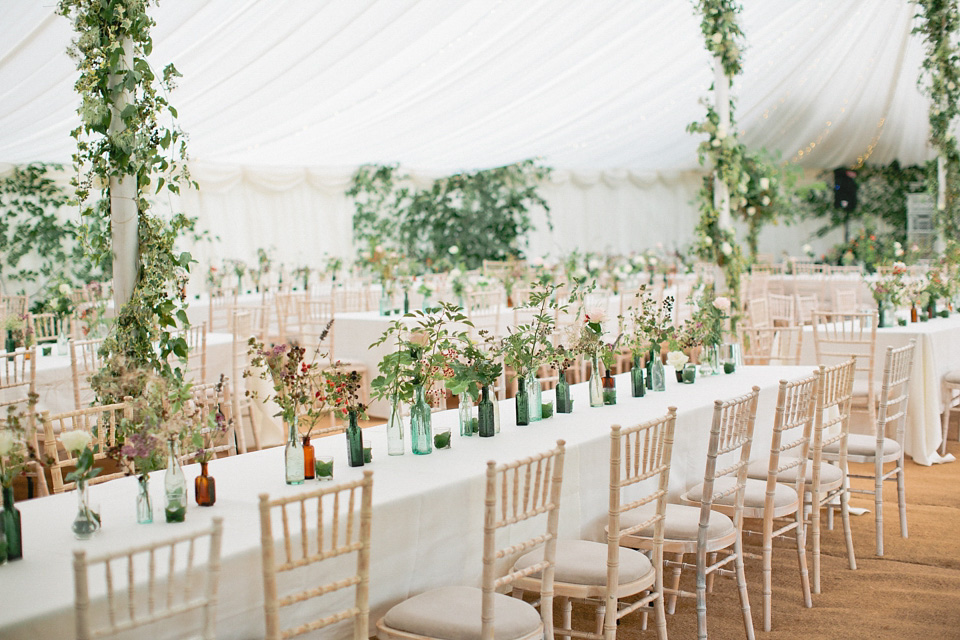 A bride wearing fresh flowers in her hair for her colourful English country garden wedding. Dress by Eponine London and photography by Rosie Anderson. eponine london, colourful wedding, english country garden wedding, rosemary anderson photography, flowers in her hair