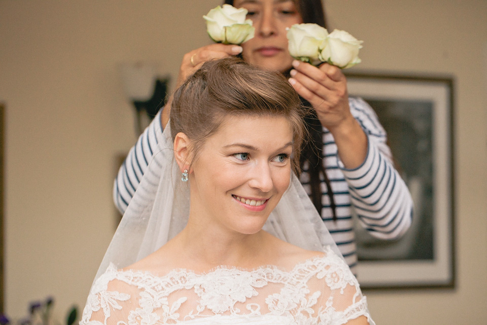 A bride wearing fresh flowers in her hair for her colourful English country garden wedding. Dress by Eponine London and photography by Rosie Anderson. eponine london, colourful wedding, english country garden wedding, rosemary anderson photography, flowers in her hair