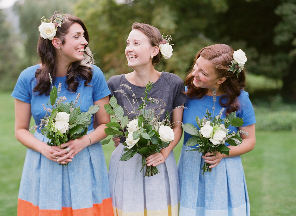 A bride wearing fresh flowers in her hair for her colourful English country garden wedding. Dress by Eponine London and photography by Rosie Anderson. eponine london, colourful wedding, english country garden wedding, rosemary anderson photography, flowers in her hair