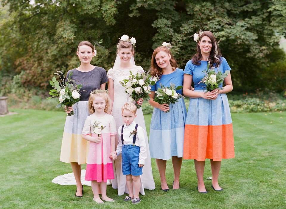A bride wearing fresh flowers in her hair for her colourful English country garden wedding. Dress by Eponine London and photography by Rosie Anderson. eponine london, colourful wedding, english country garden wedding, rosemary anderson photography, flowers in her hair