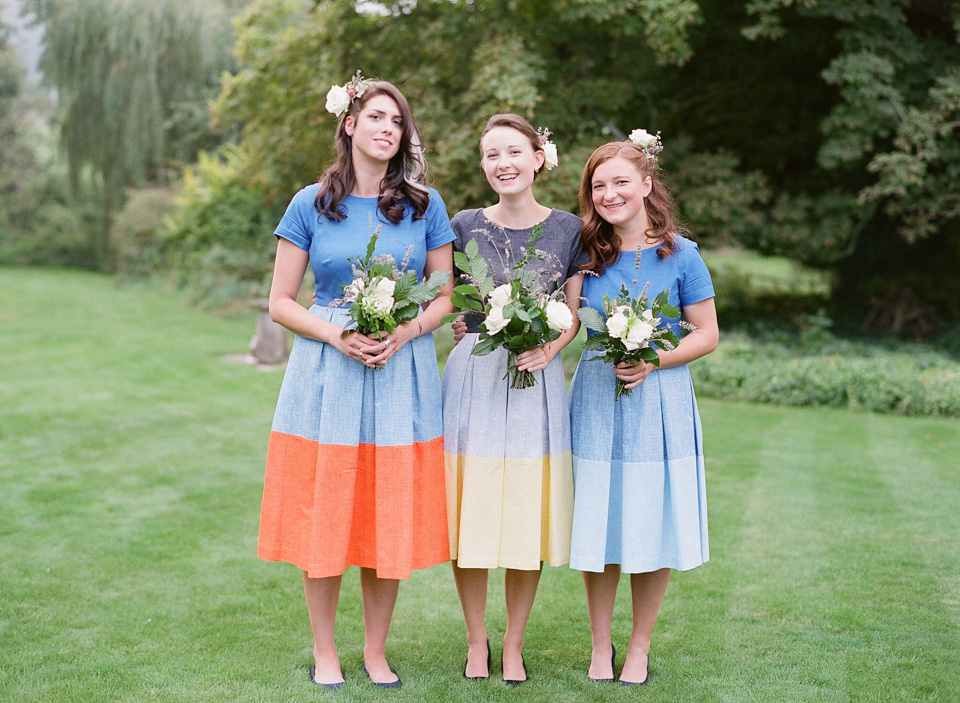 A bride wearing fresh flowers in her hair for her colourful English country garden wedding. Dress by Eponine London and photography by Rosie Anderson. eponine london, colourful wedding, english country garden wedding, rosemary anderson photography, flowers in her hair