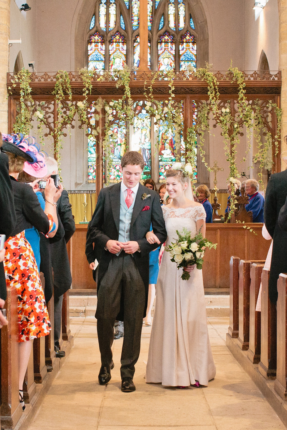 A bride wearing fresh flowers in her hair for her colourful English country garden wedding. Dress by Eponine London and photography by Rosie Anderson. eponine london, colourful wedding, english country garden wedding, rosemary anderson photography, flowers in her hair