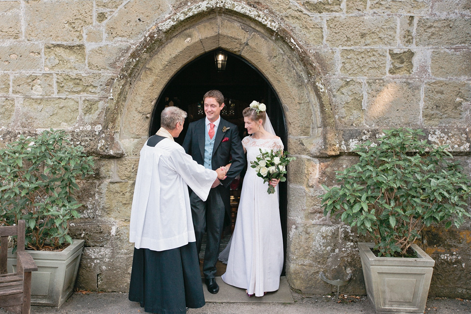 A bride wearing fresh flowers in her hair for her colourful English country garden wedding. Dress by Eponine London and photography by Rosie Anderson. eponine london, colourful wedding, english country garden wedding, rosemary anderson photography, flowers in her hair