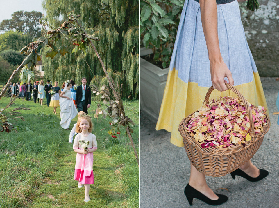 A bride wearing fresh flowers in her hair for her colourful English country garden wedding. Dress by Eponine London and photography by Rosie Anderson. eponine london, colourful wedding, english country garden wedding, rosemary anderson photography, flowers in her hair