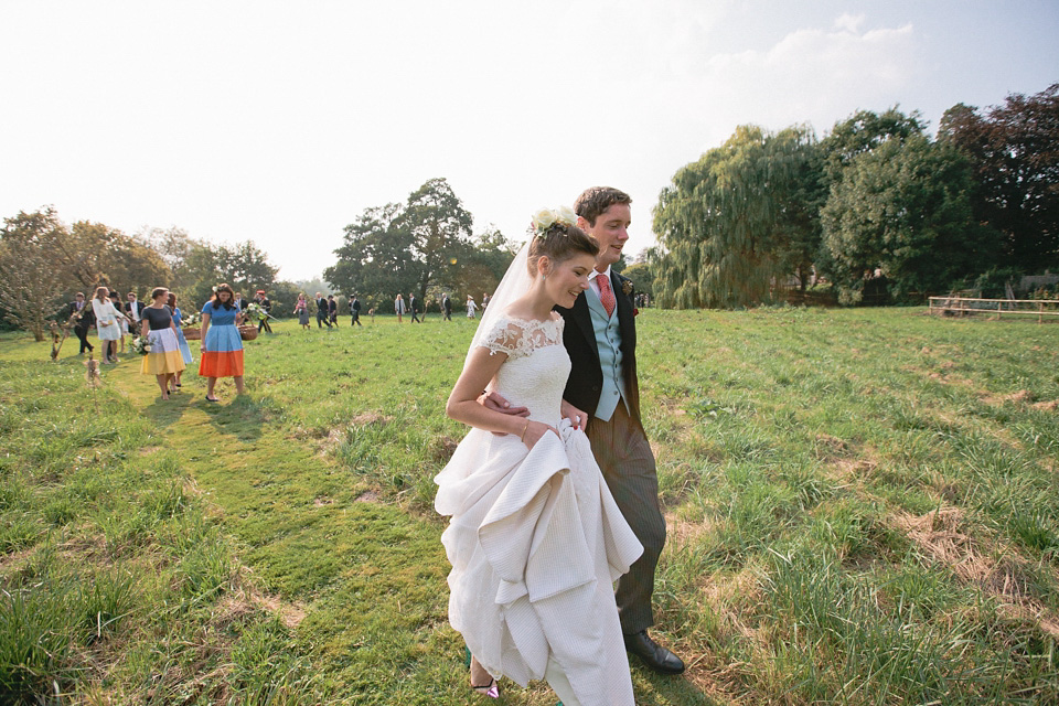 A bride wearing fresh flowers in her hair for her colourful English country garden wedding. Dress by Eponine London and photography by Rosie Anderson. eponine london, colourful wedding, english country garden wedding, rosemary anderson photography, flowers in her hair