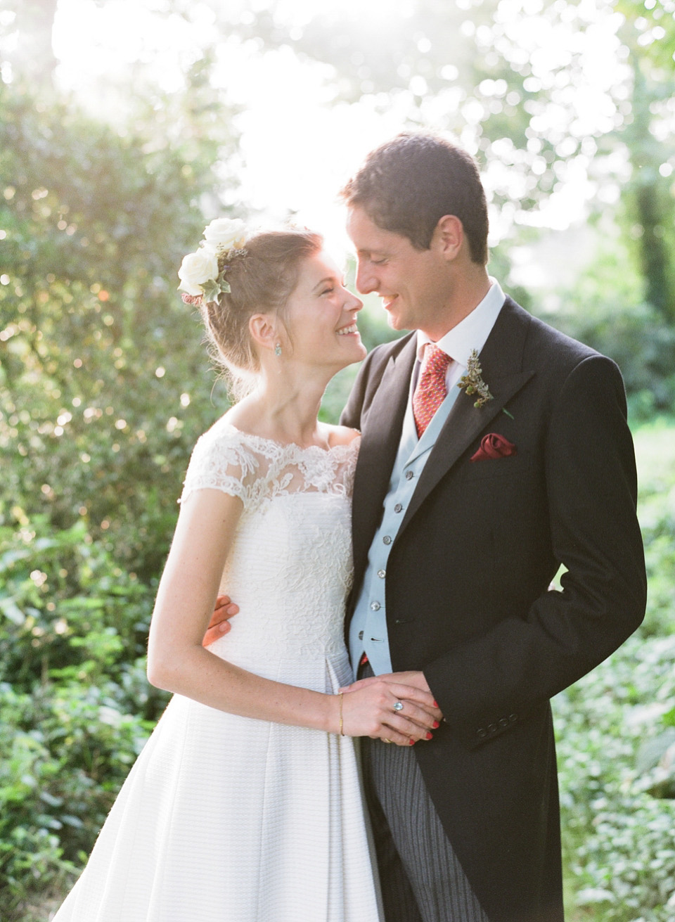 A bride wearing fresh flowers in her hair for her colourful English country garden wedding. Dress by Eponine London and photography by Rosie Anderson. eponine london, colourful wedding, english country garden wedding, rosemary anderson photography, flowers in her hair