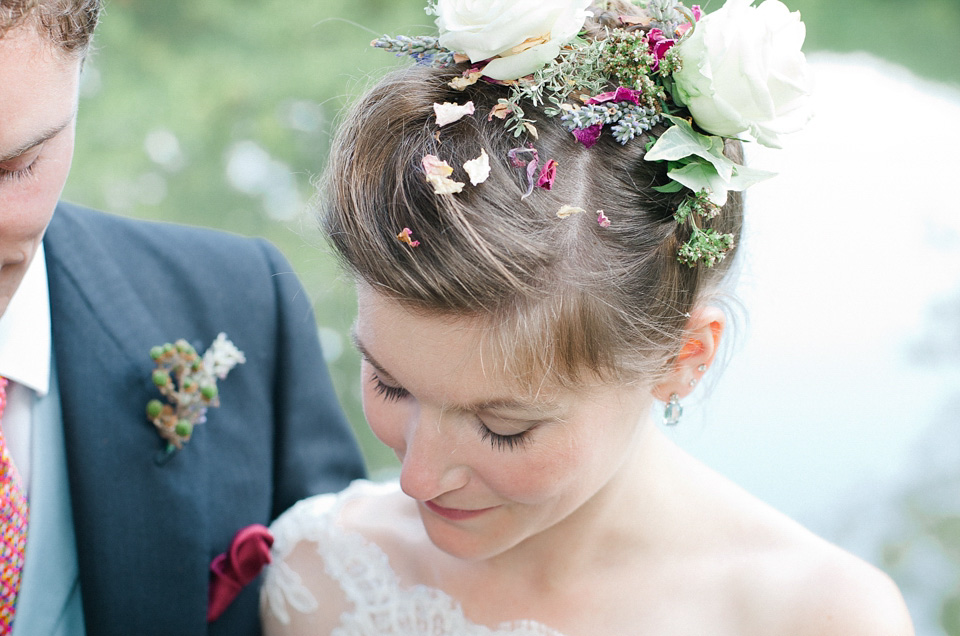 A bride wearing fresh flowers in her hair for her colourful English country garden wedding. Dress by Eponine London and photography by Rosie Anderson. eponine london, colourful wedding, english country garden wedding, rosemary anderson photography, flowers in her hair