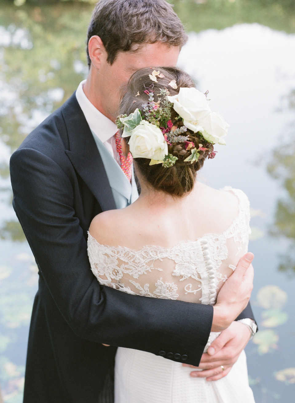 A bride wearing fresh flowers in her hair for her colourful English country garden wedding. Dress by Eponine London and photography by Rosie Anderson. eponine london, colourful wedding, english country garden wedding, rosemary anderson photography, flowers in her hair