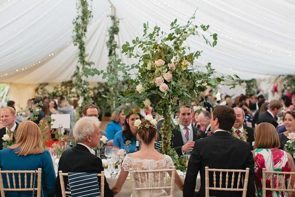 A bride wearing fresh flowers in her hair for her colourful English country garden wedding. Dress by Eponine London and photography by Rosie Anderson. eponine london, colourful wedding, english country garden wedding, rosemary anderson photography, flowers in her hair