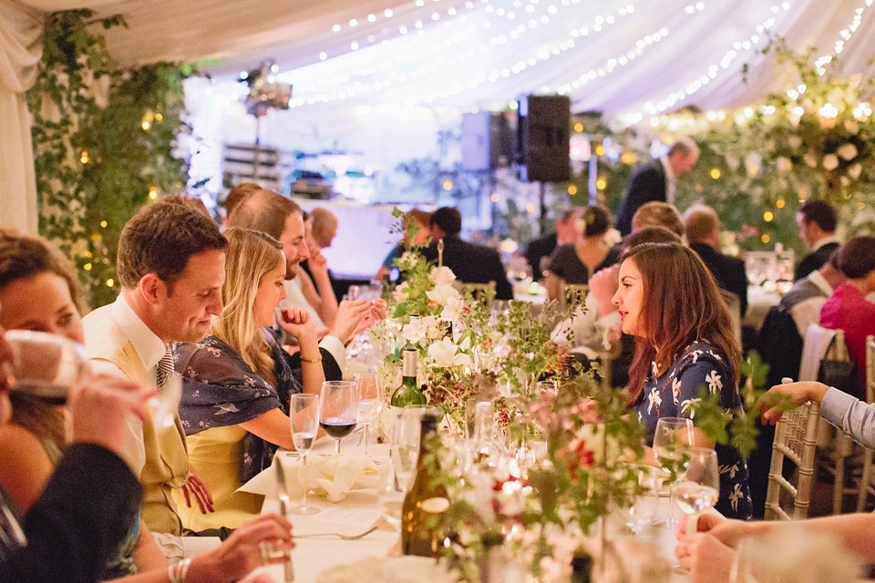 A bride wearing fresh flowers in her hair for her colourful English country garden wedding. Dress by Eponine London and photography by Rosie Anderson. eponine london, colourful wedding, english country garden wedding, rosemary anderson photography, flowers in her hair