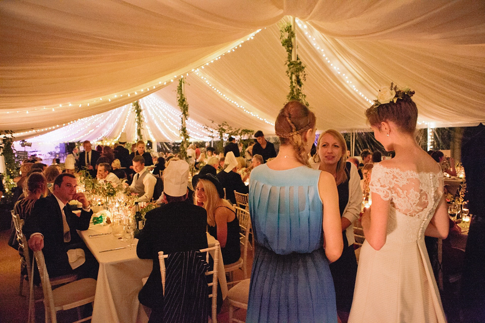A bride wearing fresh flowers in her hair for her colourful English country garden wedding. Dress by Eponine London and photography by Rosie Anderson. eponine london, colourful wedding, english country garden wedding, rosemary anderson photography, flowers in her hair