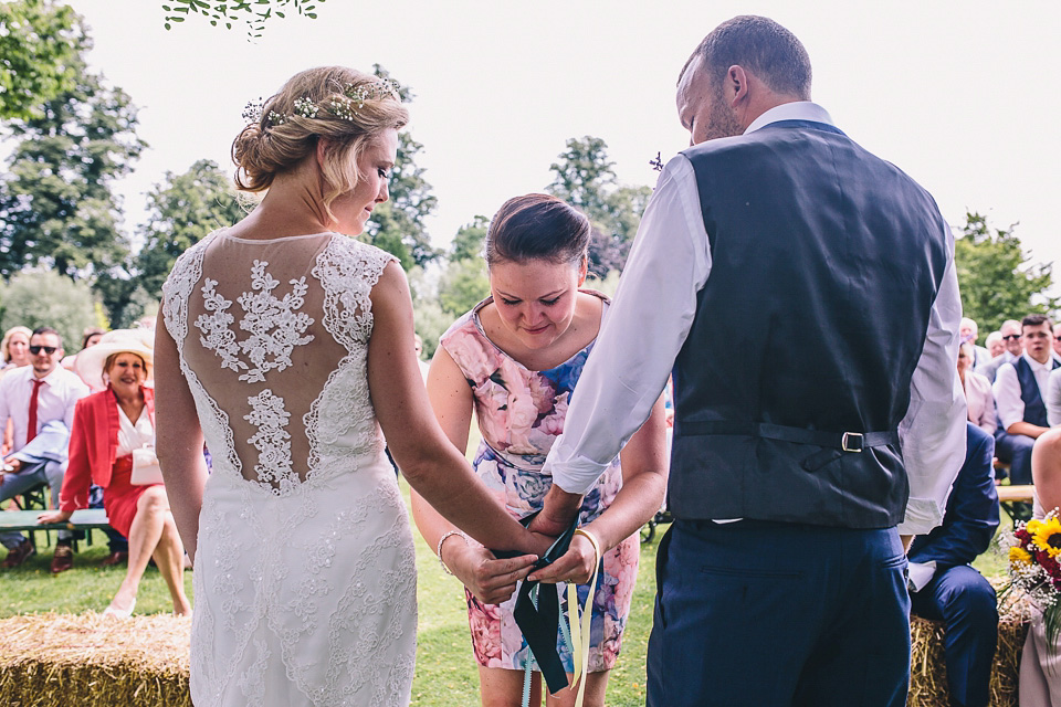 A bride wearing San Patrick for her Humanist handfasting ceremony at Talton Lodge. Photography by Sara Lincoln.