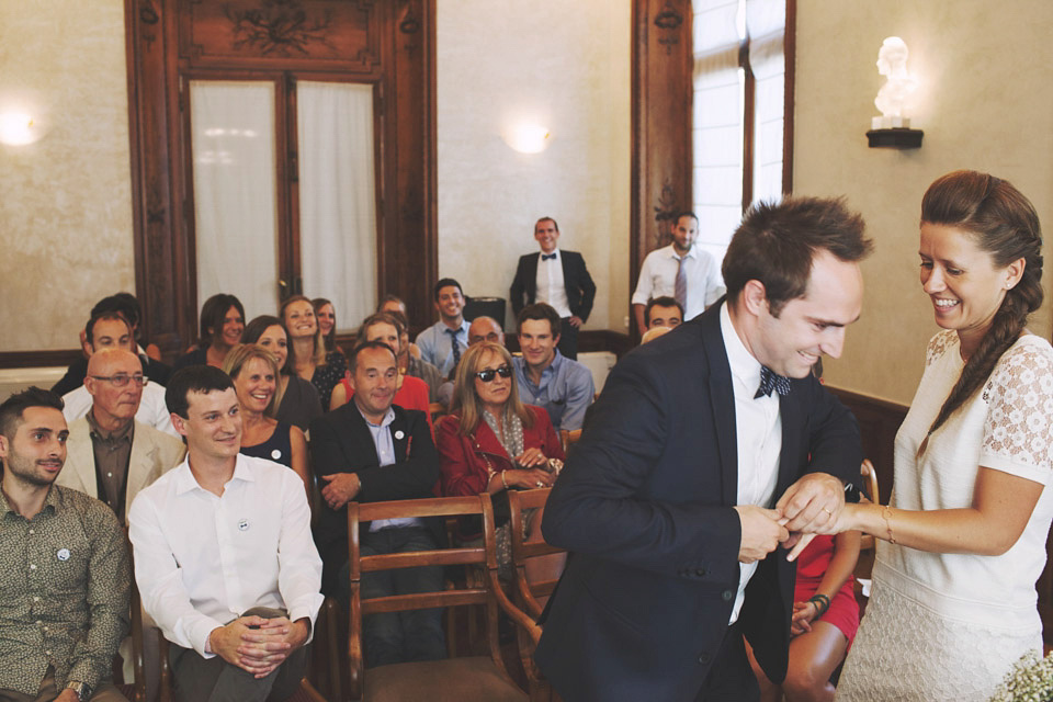 Bride and groom laughing during their wedding ceremony.  She wears Vanessa Bruno. Image by Hearts on Fire Photography.