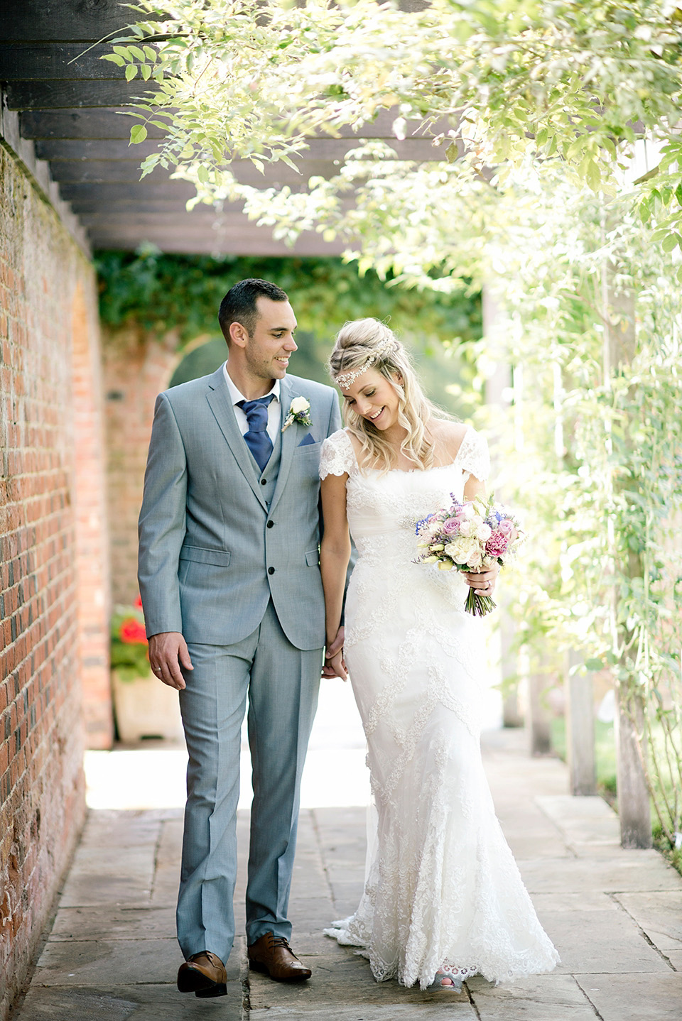 The bride wears a Bo & Luca headpiece and pretty Pronovias gown for her Summer country house wedding at Woodhall Manor in Suffolk. Photography by Kathryn Hopkins.