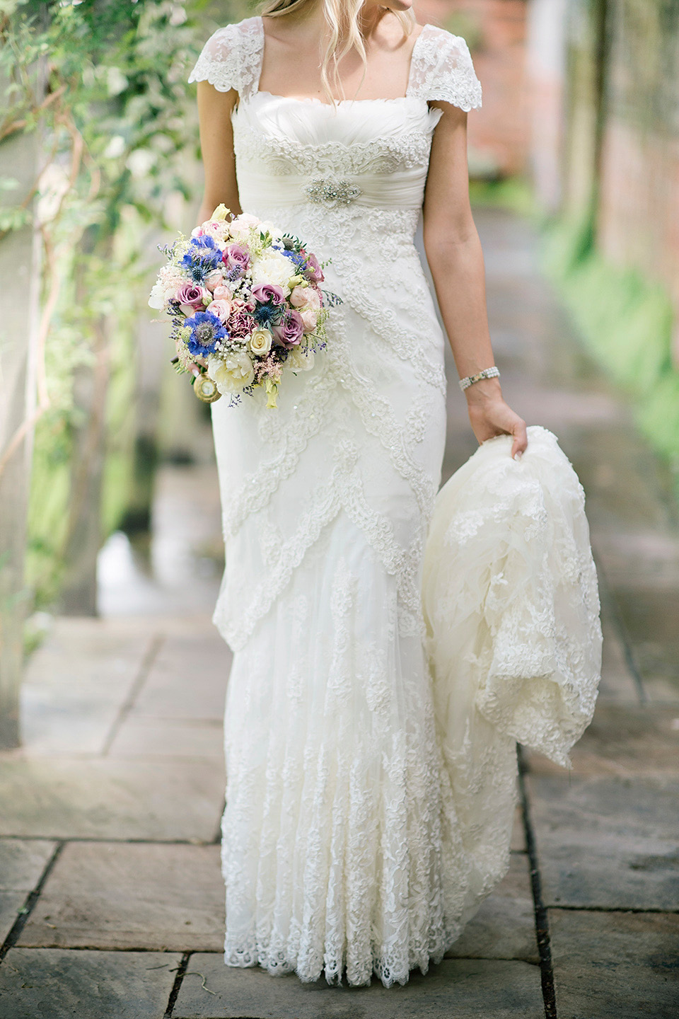 The bride wears a Bo & Luca headpiece and pretty Pronovias gown for her Summer country house wedding at Woodhall Manor in Suffolk. Photography by Kathryn Hopkins.