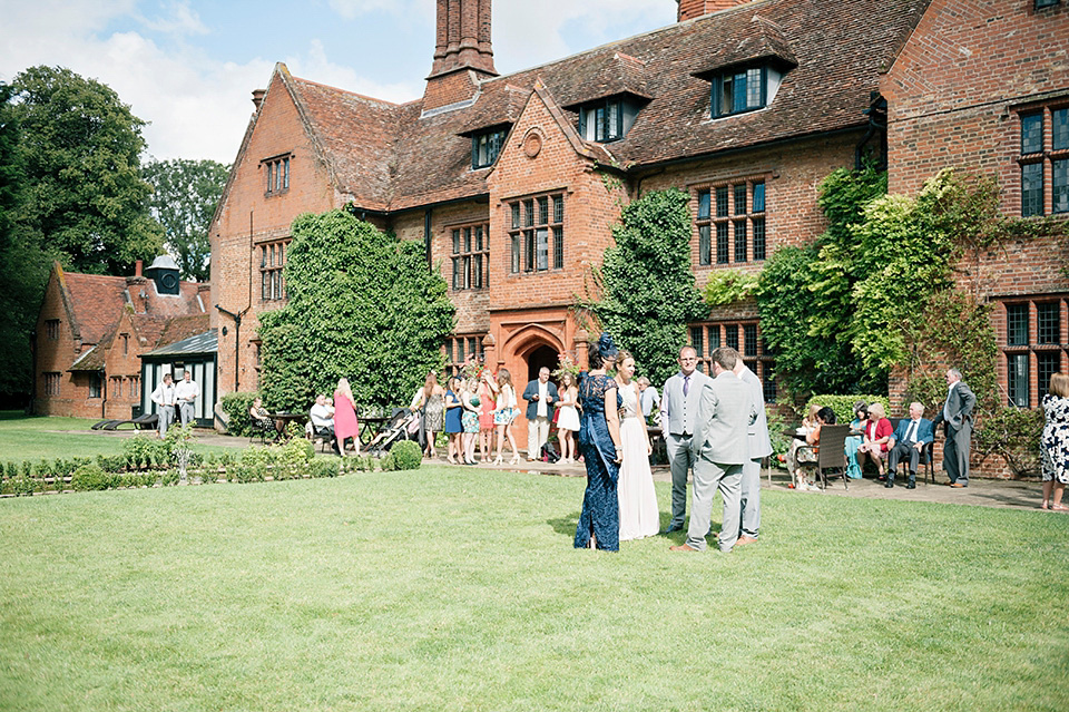 The bride wears a Bo & Luca headpiece and pretty Pronovias gown for her Summer country house wedding at Woodhall Manor in Suffolk. Photography by Kathryn Hopkins.