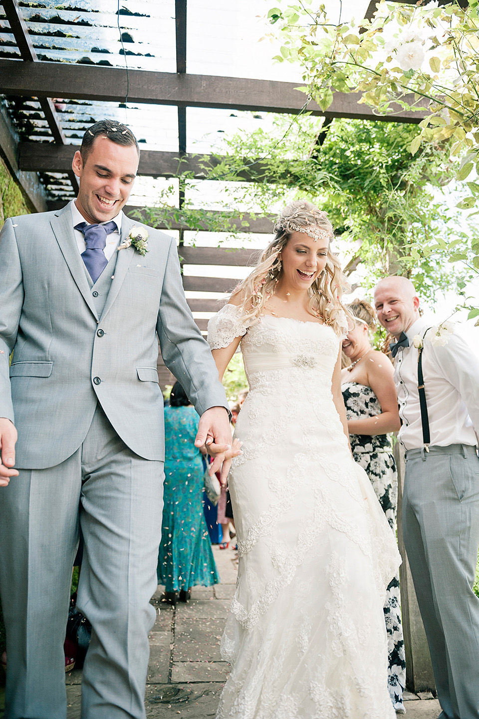 The bride wears a Bo & Luca headpiece and pretty Pronovias gown for her Summer country house wedding at Woodhall Manor in Suffolk. Photography by Kathryn Hopkins.