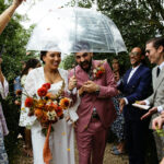 Miss Bush real bride. Groom in pink suit, bride in Jesus Peiro bridal cape.
