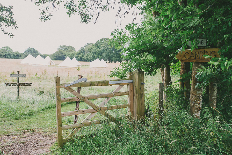 A boho bride wearing a Charlie Brear dress and veil for her woodland festival wedding at Hawthbush Farm in Sussex. Photography by Modern Vintage Weddings.