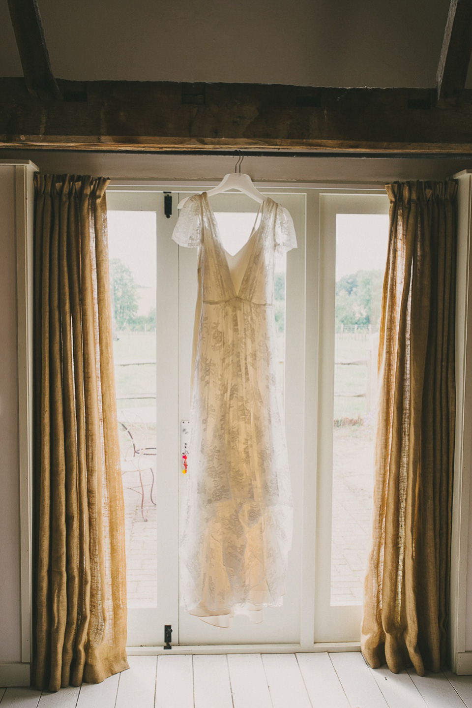A boho bride wearing a Charlie Brear dress and veil for her woodland festival wedding at Hawthbush Farm in Sussex. Photography by Modern Vintage Weddings.