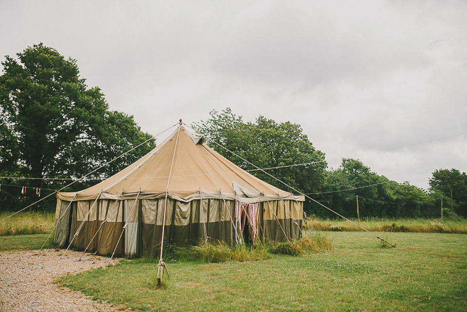 A boho bride wearing a Charlie Brear dress and veil for her woodland festival wedding at Hawthbush Farm in Sussex. Photography by Modern Vintage Weddings.