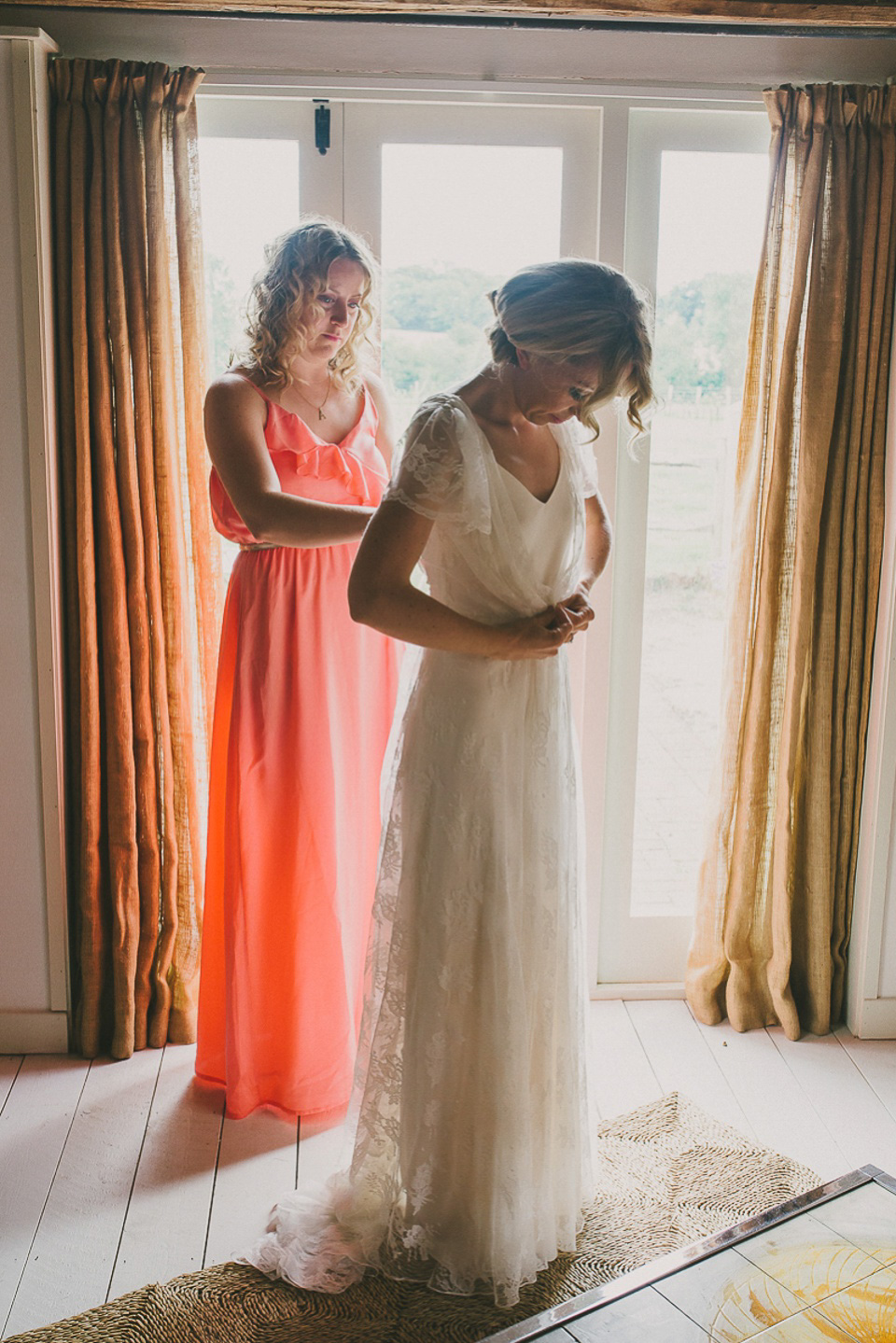 A boho bride wearing a Charlie Brear dress and veil for her woodland festival wedding at Hawthbush Farm in Sussex. Photography by Modern Vintage Weddings.