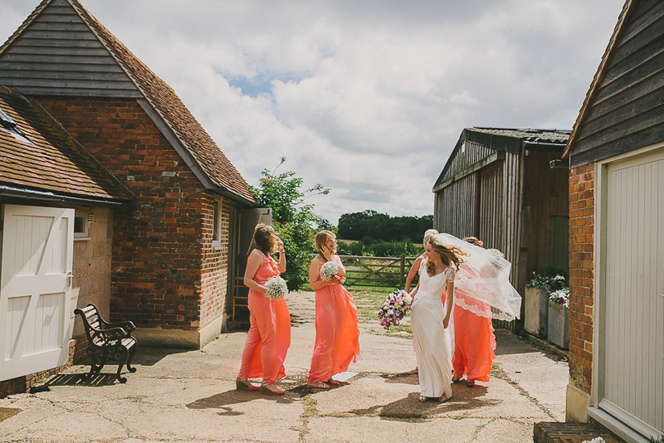 A boho bride wearing a Charlie Brear dress and veil for her woodland festival wedding at Hawthbush Farm in Sussex. Photography by Modern Vintage Weddings.