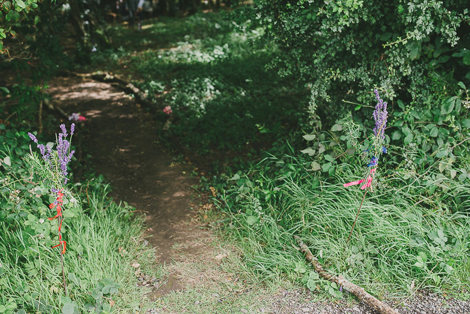 A boho bride wearing a Charlie Brear dress and veil for her woodland festival wedding at Hawthbush Farm in Sussex. Photography by Modern Vintage Weddings.