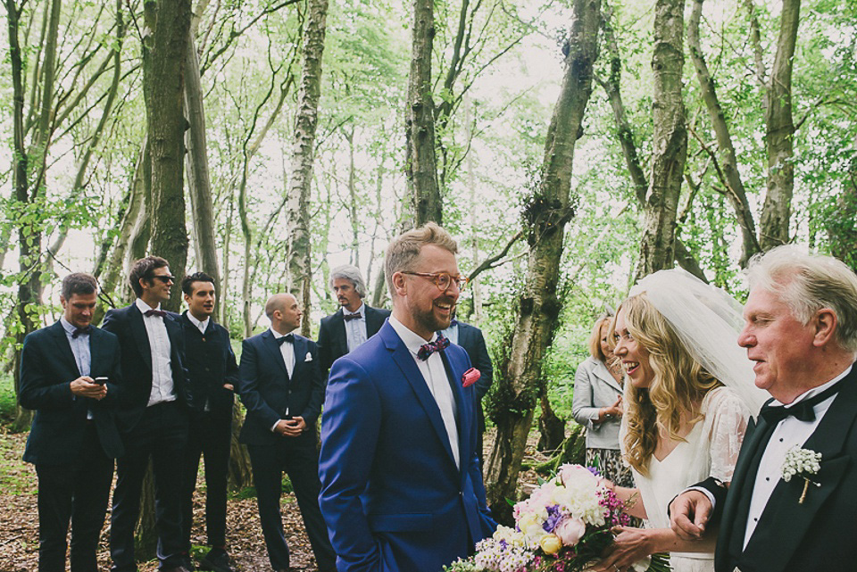 A boho bride wearing a Charlie Brear dress and veil for her woodland festival wedding at Hawthbush Farm in Sussex. Photography by Modern Vintage Weddings.