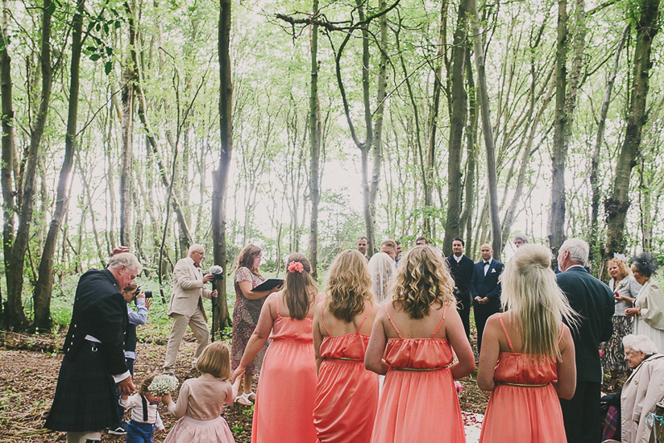 A boho bride wearing a Charlie Brear dress and veil for her woodland festival wedding at Hawthbush Farm in Sussex. Photography by Modern Vintage Weddings.