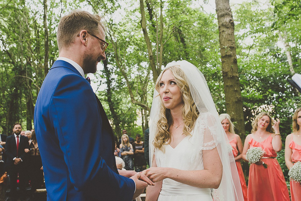 A boho bride wearing a Charlie Brear dress and veil for her woodland festival wedding at Hawthbush Farm in Sussex. Photography by Modern Vintage Weddings.