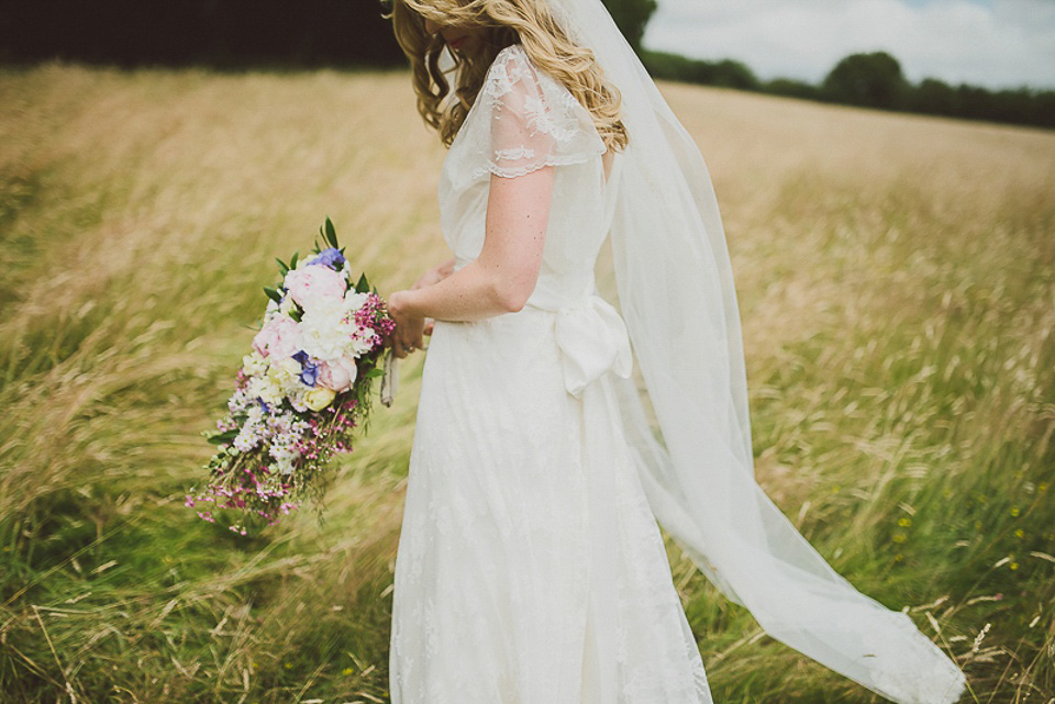 A boho bride wearing a Charlie Brear dress and veil for her woodland festival wedding at Hawthbush Farm in Sussex. Photography by Modern Vintage Weddings.