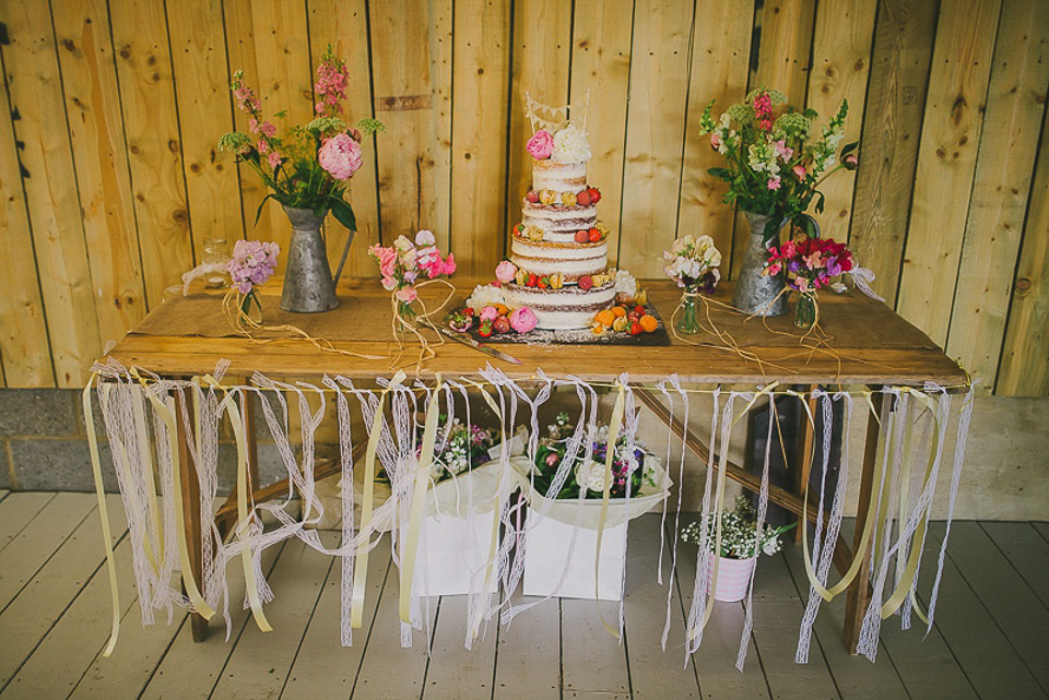 A boho bride wearing a Charlie Brear dress and veil for her woodland festival wedding at Hawthbush Farm in Sussex. Photography by Modern Vintage Weddings.