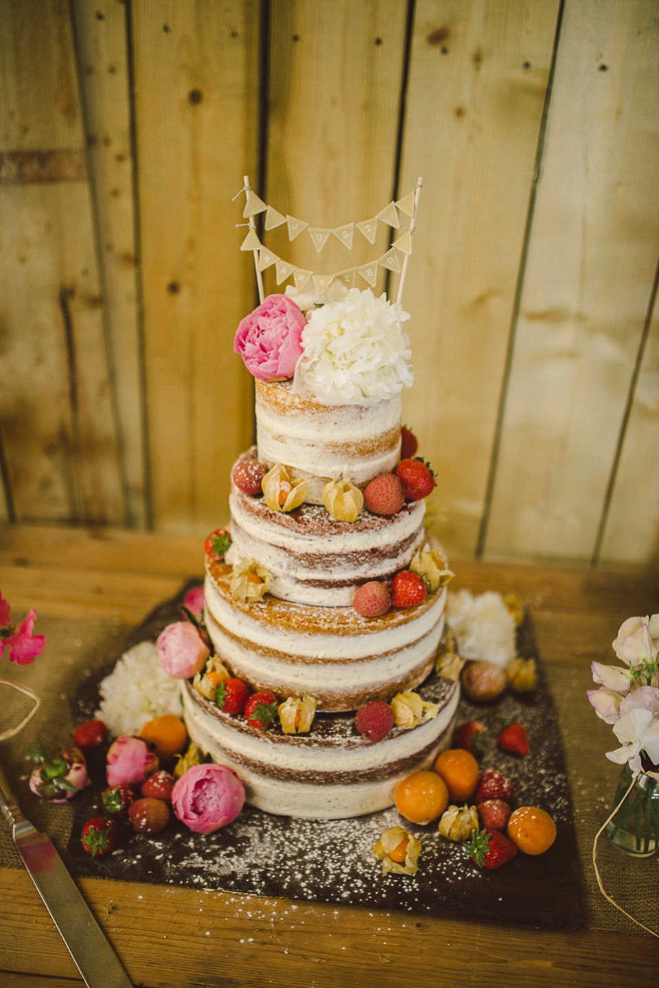 A boho bride wearing a Charlie Brear dress and veil for her woodland festival wedding at Hawthbush Farm in Sussex. Photography by Modern Vintage Weddings.