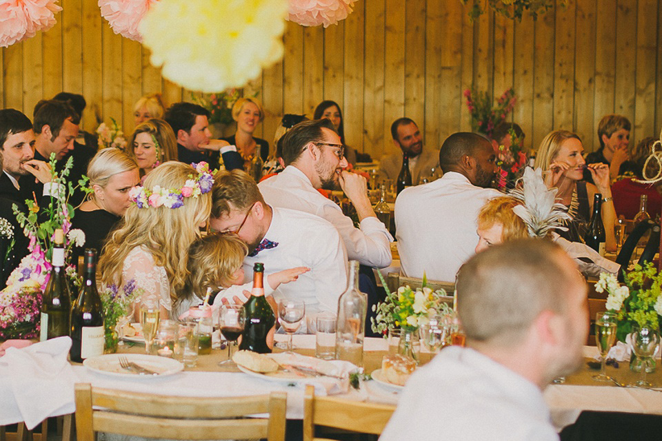 A boho bride wearing a Charlie Brear dress and veil for her woodland festival wedding at Hawthbush Farm in Sussex. Photography by Modern Vintage Weddings.