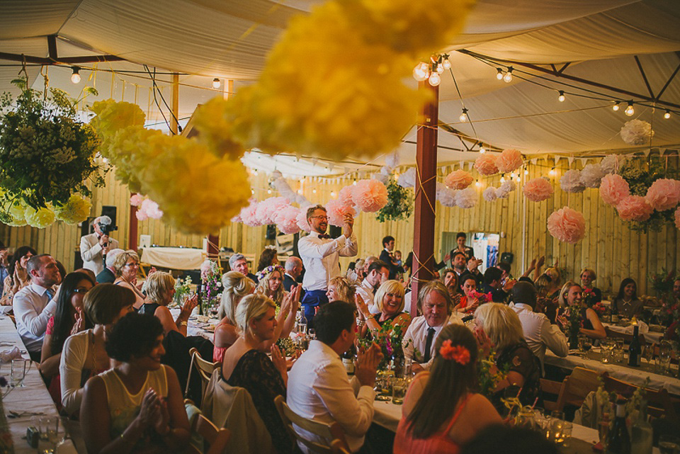 A boho bride wearing a Charlie Brear dress and veil for her woodland festival wedding at Hawthbush Farm in Sussex. Photography by Modern Vintage Weddings.