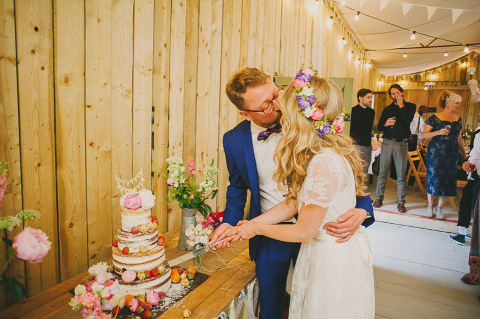 A boho bride wearing a Charlie Brear dress and veil for her woodland festival wedding at Hawthbush Farm in Sussex. Photography by Modern Vintage Weddings.