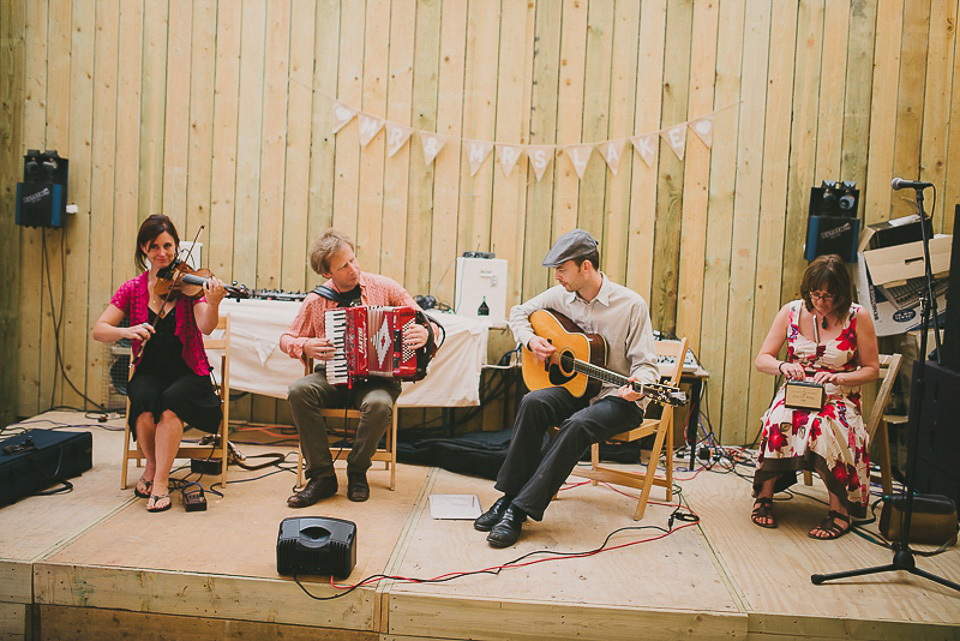 A boho bride wearing a Charlie Brear dress and veil for her woodland festival wedding at Hawthbush Farm in Sussex. Photography by Modern Vintage Weddings.