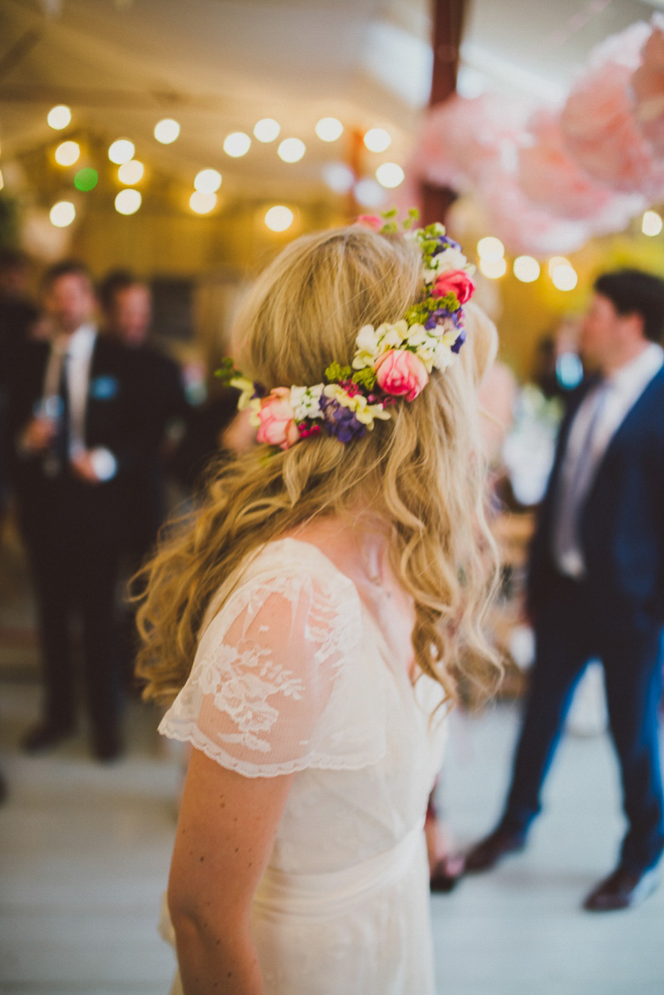 A boho bride wearing a Charlie Brear dress and veil for her woodland festival wedding at Hawthbush Farm in Sussex. Photography by Modern Vintage Weddings.