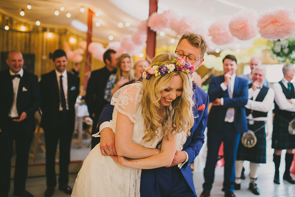 A boho bride wearing a Charlie Brear dress and veil for her woodland festival wedding at Hawthbush Farm in Sussex. Photography by Modern Vintage Weddings.