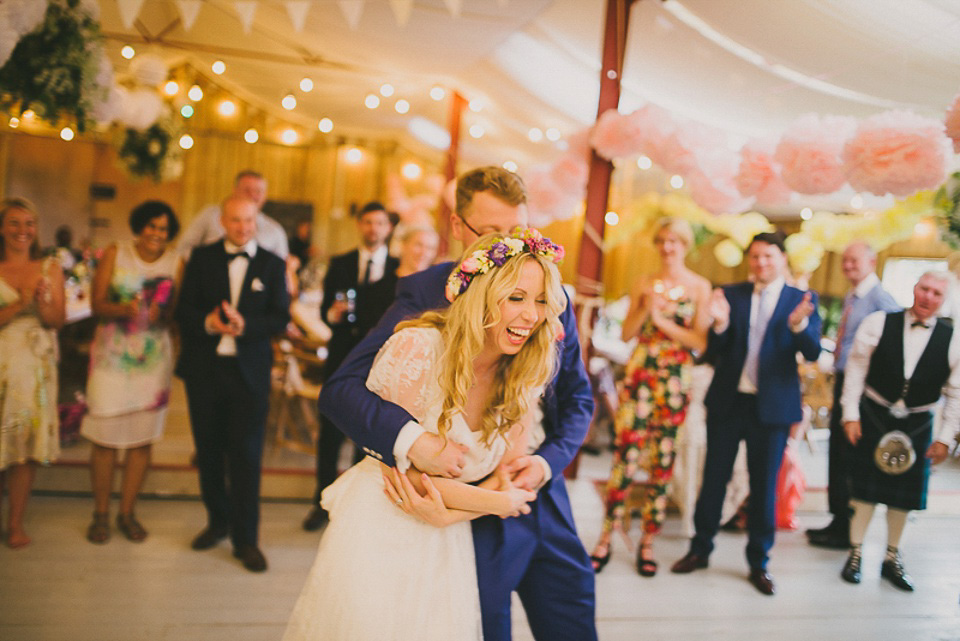 A boho bride wearing a Charlie Brear dress and veil for her woodland festival wedding at Hawthbush Farm in Sussex. Photography by Modern Vintage Weddings.