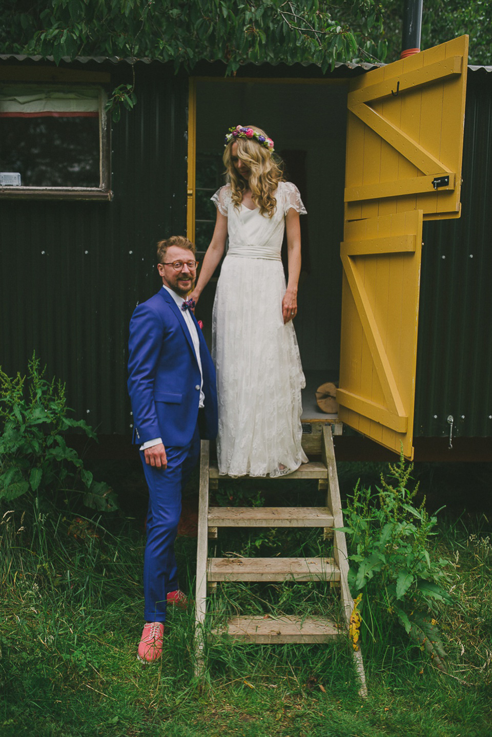 A boho bride wearing a Charlie Brear dress and veil for her woodland festival wedding at Hawthbush Farm in Sussex. Photography by Modern Vintage Weddings.