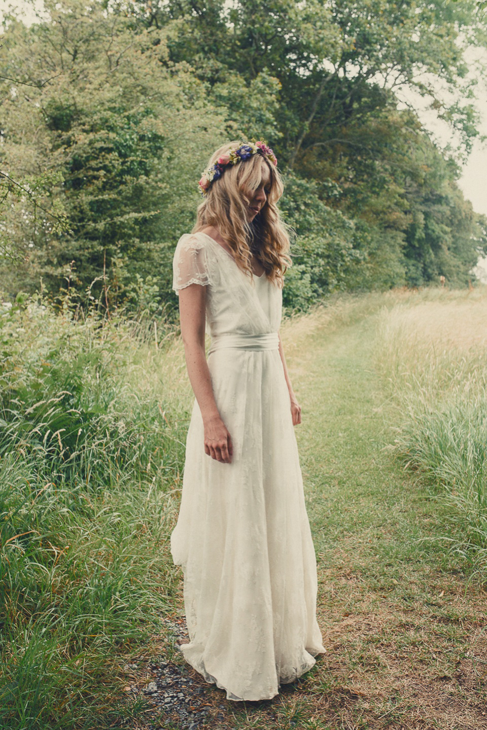 A boho bride wearing a Charlie Brear dress and veil for her woodland festival wedding at Hawthbush Farm in Sussex. Photography by Modern Vintage Weddings.