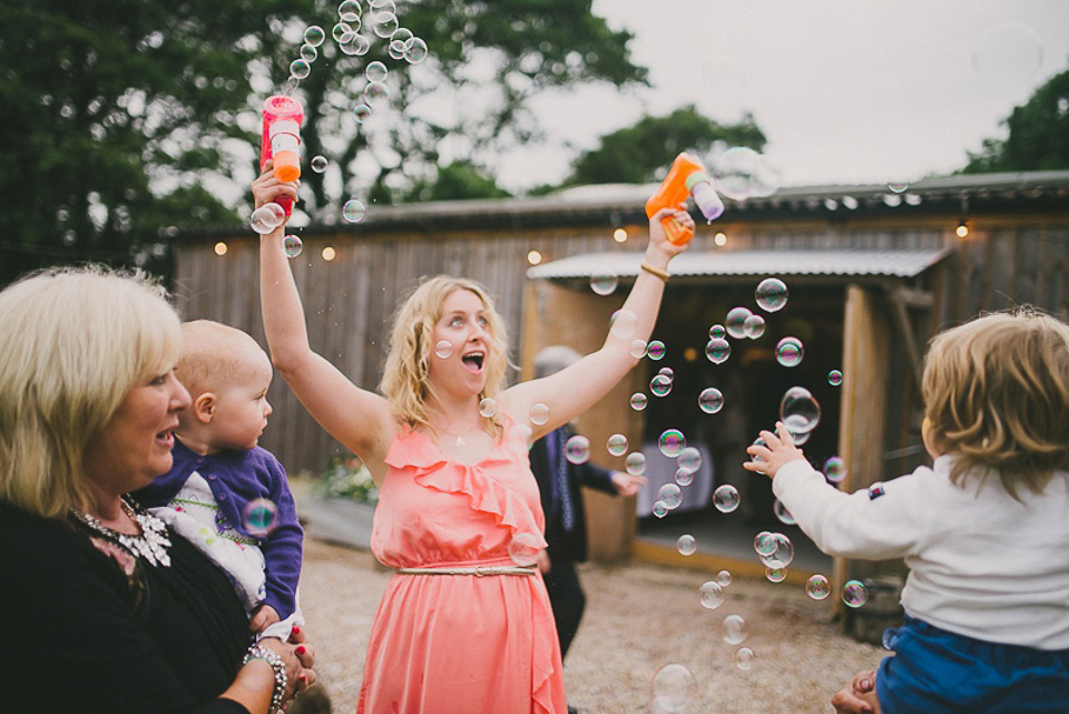 A boho bride wearing a Charlie Brear dress and veil for her woodland festival wedding at Hawthbush Farm in Sussex. Photography by Modern Vintage Weddings.