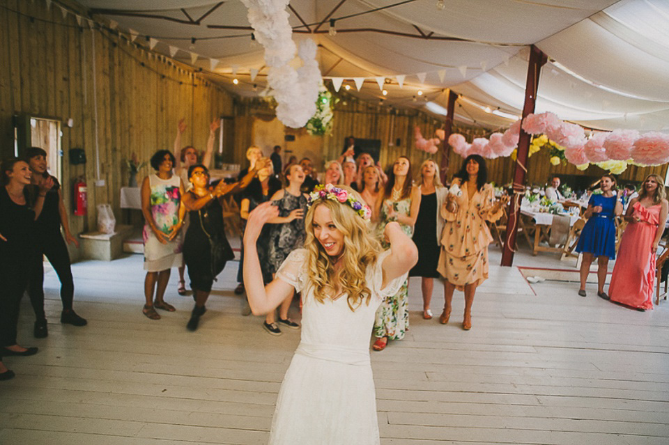 A boho bride wearing a Charlie Brear dress and veil for her woodland festival wedding at Hawthbush Farm in Sussex. Photography by Modern Vintage Weddings.