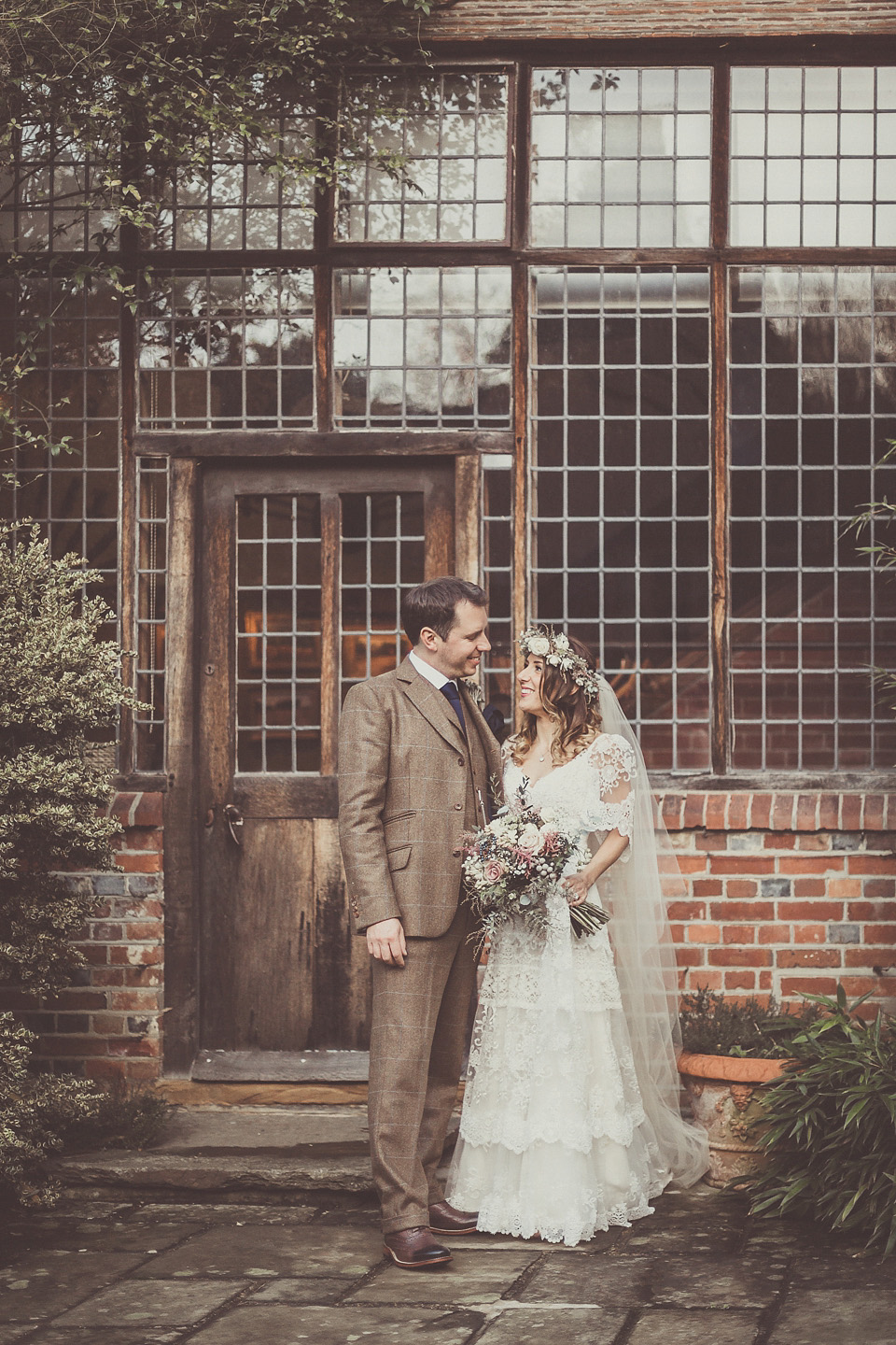 The bride wears YolanCris for her rustic, late Autumn barn wedding at Ramster Hall in Chiddingford, Surrey. Photography by Michelle Lindsell.