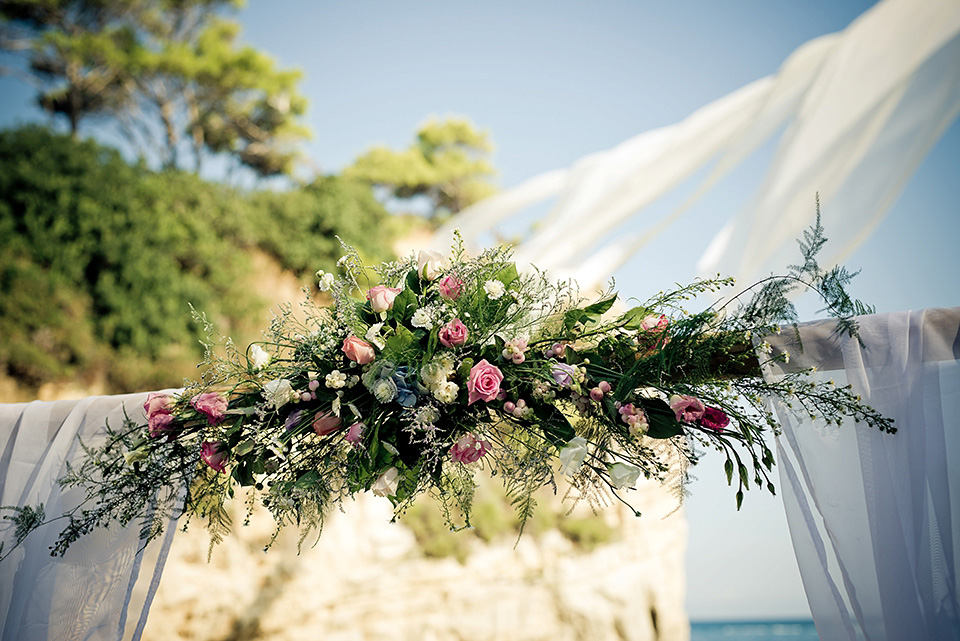 A destinatoin wedding in Zakynthos, Greece. The bride wears Ronald Joyce and her maids wear twobirds Bridesmaid.  Photography by Nick Kontostavlakis.